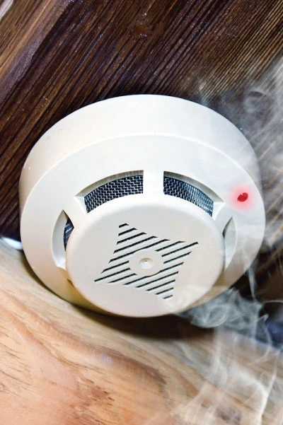 a fire smoke alarm beeping due to detecting smoke